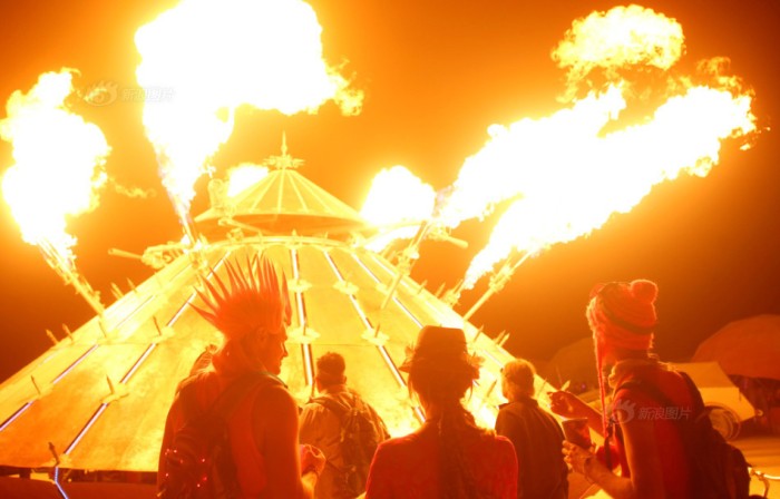 Participants watch the flames of the mutant vehicle as approximately 70,000 people from all over the world gather for the 30th annual Burning Man arts and music festival in the Black Rock Desert of Nevada, U.S.