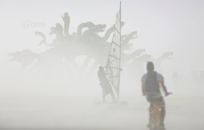 Dust blows past an art installation as approximately 70,000 people from all over the world gather for the 30th annual Burning Man arts and music festival in the Black Rock Desert of Nevada, U.S.